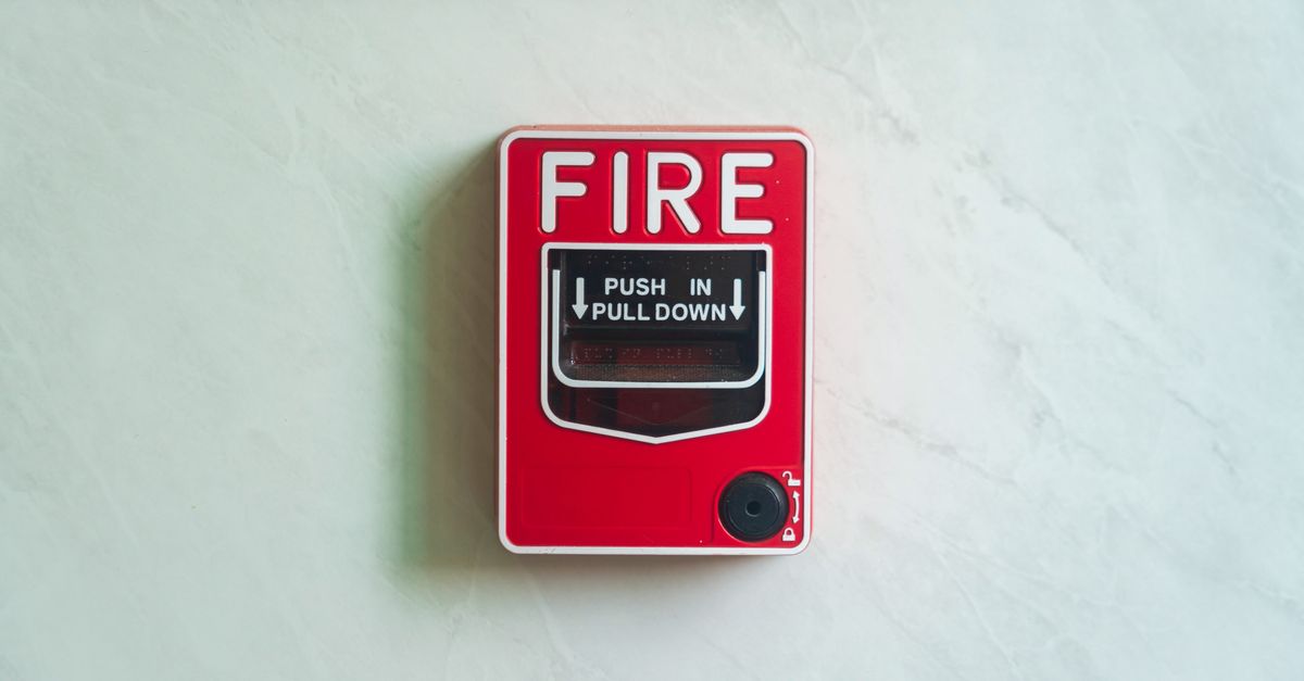 Image of a wall mounted red fire alarm device for safety alerts and emergency preparedness.